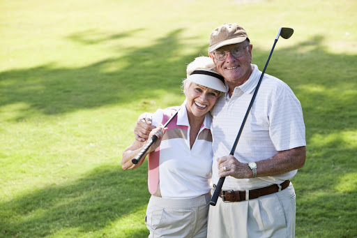 senior couple, 70s, on the golf course.